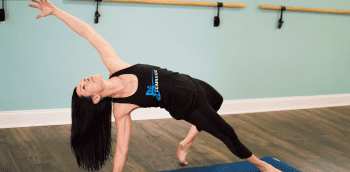 Yoga instructor stretching at Be Moved Fitness studio in North Tonawanda, NY