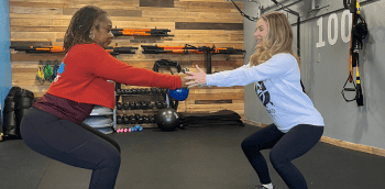 Two Be Moved Fitness trainers using resistance bands during a workout in North Tonawanda, NY