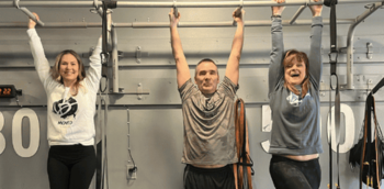 Be Moved Fitness trainers smiling and raising arms during a workout in North Tonawanda, NY